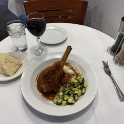 It's Greek To Me - The full course,lamb shank dish, pita bread and a glass of Cabernet!