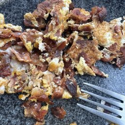 Scrambled eggs and bacon which were scorched