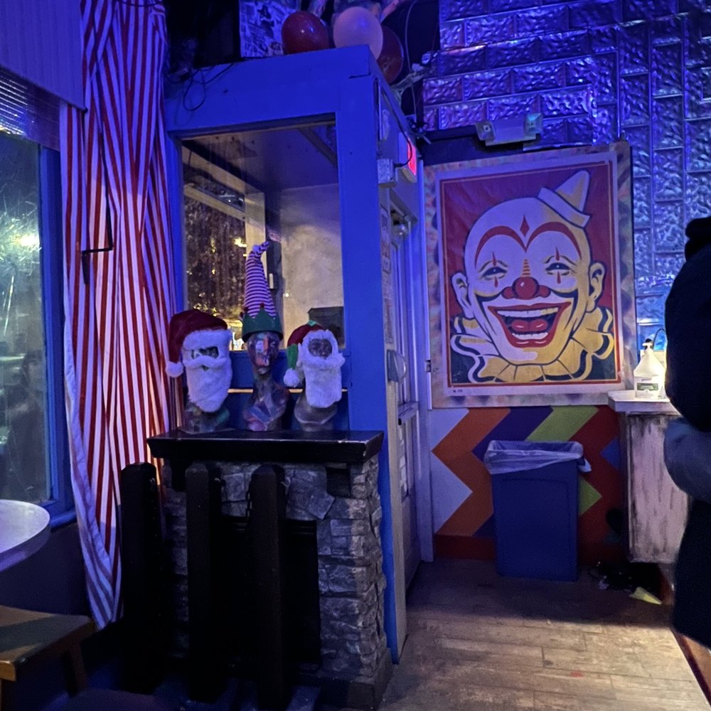 Wonderland - a clown's face on the wall of a bar - Dive Bars Near Me - Richmond, Virginia