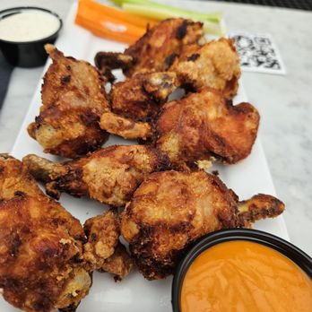Leinie Lodge & Beer Garden - Wings are lightly breaded... I got sauce on side - Beer Gardens Near Me - Baltimore, Maryland Leinie Lodge & Beer Garden - Wings are lightly breaded... I got sauce on side - Beer Gardens Near Me - Baltimore, Maryland