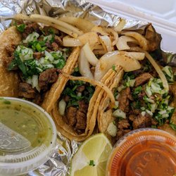 Three Carne Asada tacos with two side sauce