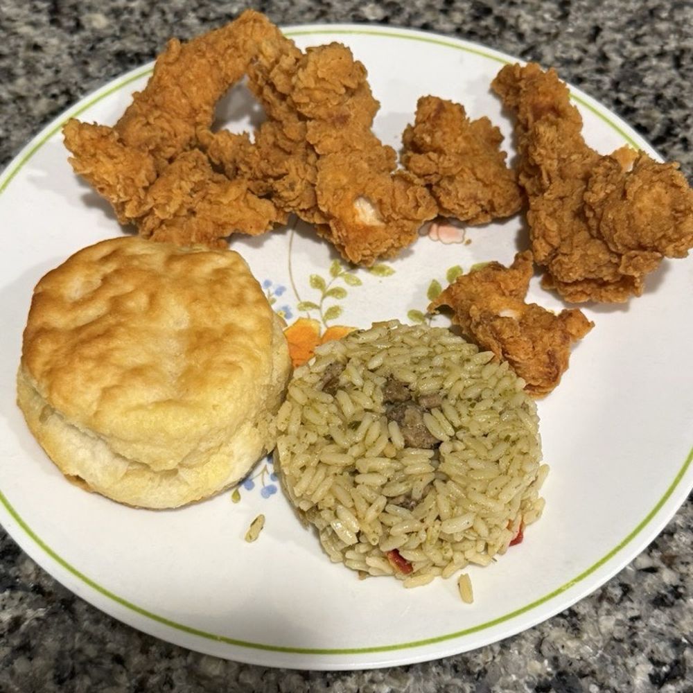 3 piece chicken strips with dirty rice and biscuit. 3 piece chicken strips with dirty rice and biscuit.