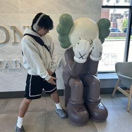 they got the kaws statue in here  posted up with gang
