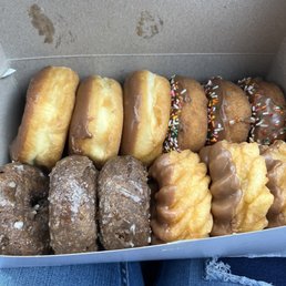 A dozen doughnuts! 3 chocolates glazed, 3 chocolate, 3 chocolate frosting with sprinkles, and 3 crinkle chocolate frosting doughnuts!