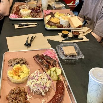 Interstellar BBQ - The tray at the bottom of this pic included chopped brisket, smoked sausage, pork ribs, smoked lamb, slaw, potato salad & carrot cake - Barbeque Near Me - Austin, Texas