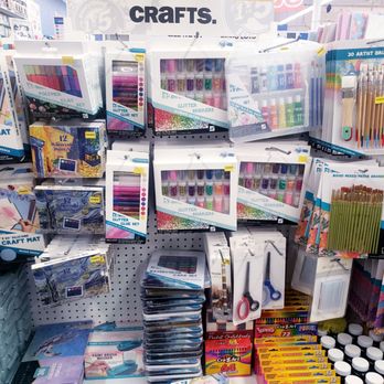 Five Below - A store shelf holds craft supplies such as glitter shakers, paint sets, scissors, and brushes, with packaging and price tags visible. - Discount Store Near Me - Palmdale, California