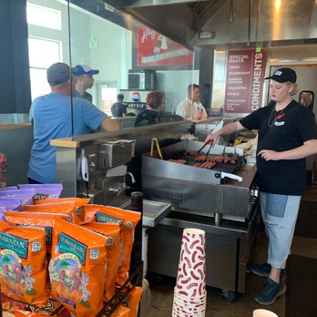 J Dawgs - a man preparing food in a restaurant - New American Near Me - Lehi, Utah