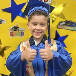 Sunrise Preschools - Graduation day joy! Another proud moment as a child celebrates a fun milestone with a beaming smile.