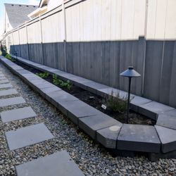 Raised flower bed, landscape lighting, walkway installation.