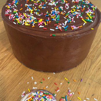 Betts Bakes - 3 layers of classic yellow cake topped with chocolate buttercream frosting and sprinkles. - Cupcakes Near Me