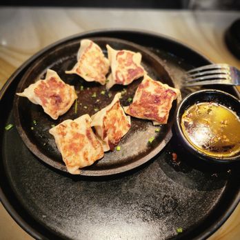 P.F. Chang's - a plate of dumplings and dipping sauce - Asian Fusion Near Me - Natick, Massachusetts P.F. Chang's - a plate of dumplings and dipping sauce - Asian Fusion Near Me - Natick, Massachusetts