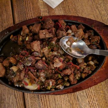 Purple Patch - Sizzling sisig - a salty, steaming, pork-belly entree served with egg on top (which can be mixed). - Filipino Near Me - Washington, DC, District of Columbia