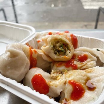 King Dumplings - a close up of a container of food - Chinese Near Me - New York, New York King Dumplings - a close up of a container of food - Chinese Near Me - New York, New York