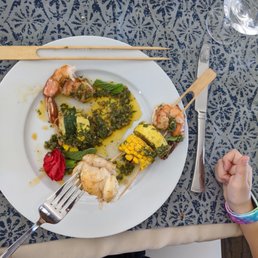 One of the delicious dishes of shrimp, lobster, grilled courgettes and corn, all topped with an amazing sauce.