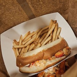 Lobster rolls stacked on top of each other in a bag.
