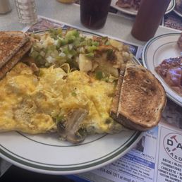 Veggie omelet, homefries with peppers and onions, toast and side order of bacon Veggie omelet, homefries with peppers and onions, toast and side order of bacon