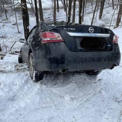 Tow Boss Towing & Recovery - Car that slid over hill into ditch stopped by tree