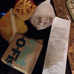 a receipt, a burger and a drink a receipt, a burger and a drink