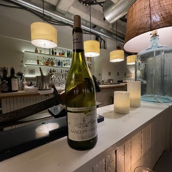 Violet - Bottle of wine on counter. - New American Near Me - Seattle, Washington