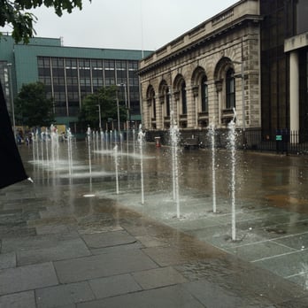 Custom House Square - River Farset underneath the water fountain - Music Venues Near Me