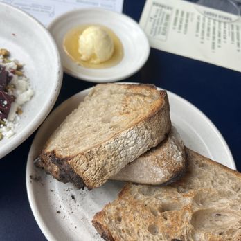 Andros Taverna - This simple bread with honey is addictive- I ate the whole plate by myself. My friends had to buy another serving! - Greek Near Me - Chicago, Illinois