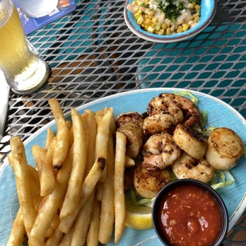 Beach Waves Grill - Shrimp and scallops entree with fries and Mexican street corn. - Seafood Near Me - Indian Rocks Beach, Florida Beach Waves Grill - Shrimp and scallops entree with fries and Mexican street corn. - Seafood Near Me - Indian Rocks Beach, Florida