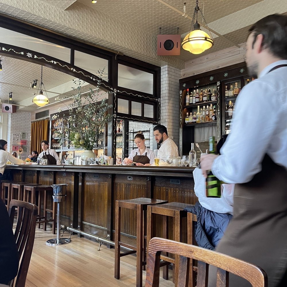 Corner Bar - people sitting at tables in a restaurant - New American Near Me - New York, New York