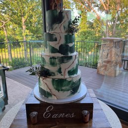 a three tiered cake decorated with greenery a three tiered cake decorated with greenery