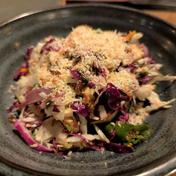 Banshee - Charred Cabbage Salad. $12. Grilled tofu skin, shishito, crispy garlic, lime vinaigrette, toasted coconut. - New American Near Me - Atlanta, Georgia