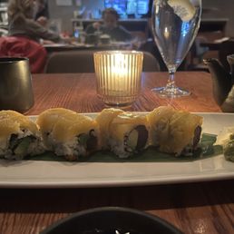 Tuna sush roll topped with peach. Tuna sush roll topped with peach.