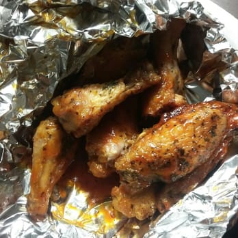 Pizza Joint - a plate of chicken wings wrapped in tin foil - Pizza Near Me - Sudbury, Ontario