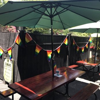 The Standard - a picnic table with umbrellas - Dive Bars Near Me - Portland, Oregon