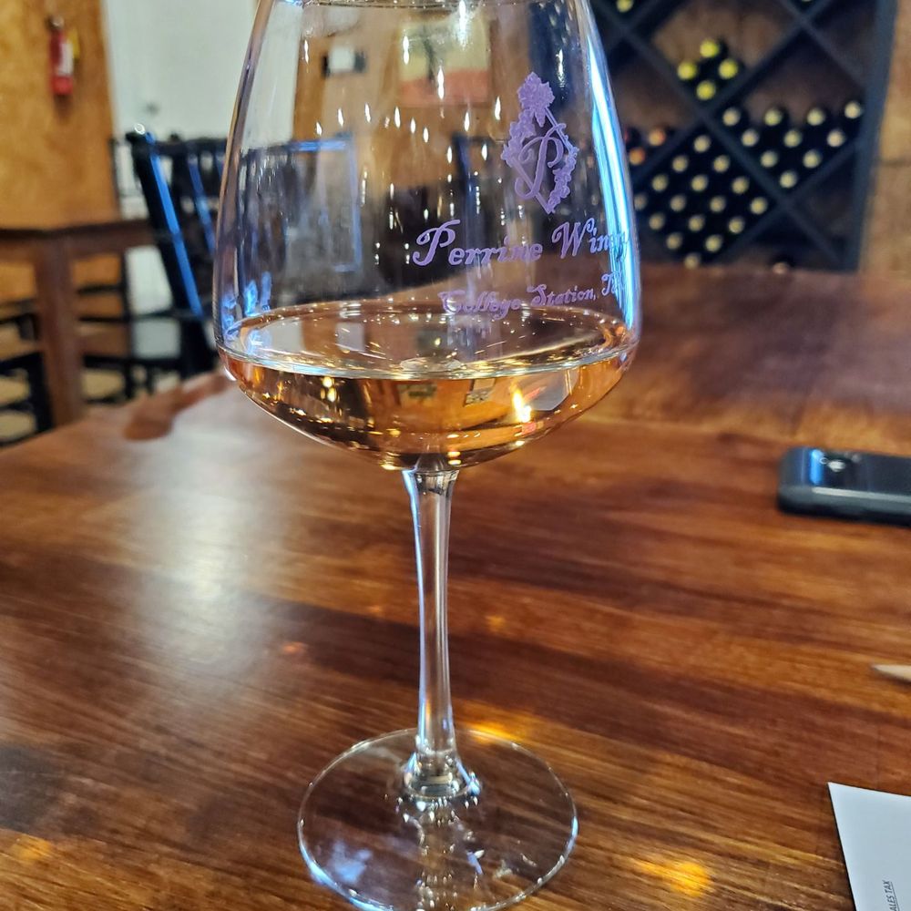 Perrine Winery - a glass of wine on a table - Wineries Near Me - College Station, Texas Perrine Winery - a glass of wine on a table - Wineries Near Me - College Station, Texas