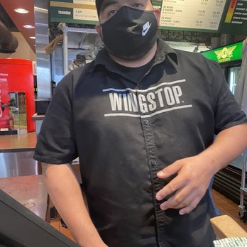 Wingstop - Cashier who stood in the way as I attempted to get the photo of food handlers NOT wearing masks. - Chicken Wings Near Me - San Angelo, Texas