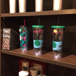 a shelf of starbucks cups and coffee mugs
