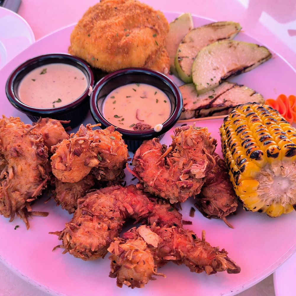 Coconut shrimp with potato and cheese cakes, corn and squash.