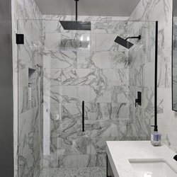 JR General Home Repair & Hardscape - Custom shower remodel with glass enclosure and pebble tile floor.