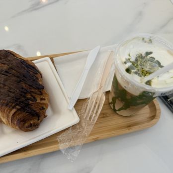 Sweet Eye Coffee - Chocolate Croissant with Iced Pistachio Latte - Coffee Roasteries Near Me - Cordova, Tennessee Sweet Eye Coffee - Chocolate Croissant with Iced Pistachio Latte - Coffee Roasteries Near Me - Cordova, Tennessee