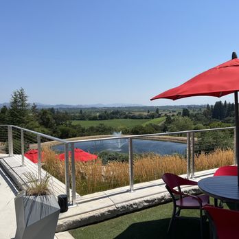 Overshine Wine - a view of a patio with tables and umbrellas - Wineries Near Me - Healdsburg, California Overshine Wine - a view of a patio with tables and umbrellas - Wineries Near Me - Healdsburg, California