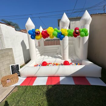 Fun Flatables - Elmo's world setup featuring our white "mini TRIO" bouncer - Bounce House Rentals Near Me