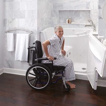 American Tubs - a woman in a wheelchair in a bathroom - General Contractors Near Me - Benton, Arkansas American Tubs - a woman in a wheelchair in a bathroom - General Contractors Near Me - Benton, Arkansas