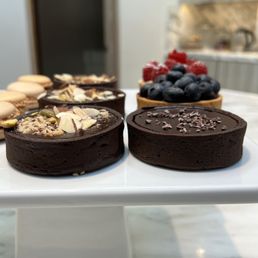 Raspberry Tartelette, Chocolate ganache tartelette, and macarons Raspberry Tartelette, Chocolate ganache tartelette, and macarons
