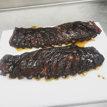 BIG J's BBQ - two ribs on a cutting board - Barbeque Near Me - Jacksonville, North Carolina