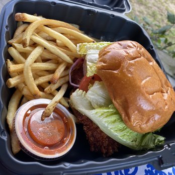 27 North - "Cluck Norris" fried chicken sandwich with Buffalo sauce, lettuce, tomato, onion and a side of fries - Breakfast & Brunch Near Me - Conway, New Hampshire