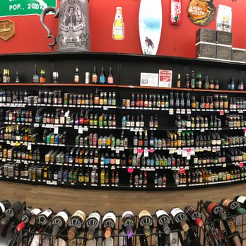 Cellar Wine & Spirits - a wine rack with wine bottles - Beer, Wine & Spirits Near Me - Norman, Oklahoma