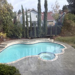 pool with pebble finish with travertine coping. New deck with pavers