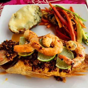 Mismaloya Grill - Shrimp and Snapper done Scarlett style, pan fried with a paste of garlic and crushed red pepper.  The potato was twice baked - Salad Near Me - Puerto Vallarta, JAL