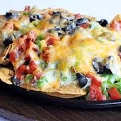 foley taco and bean - Nachos topped with cheese, peppers, and a side of Dan's homemade salsa