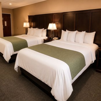 Alleghany Inn - Updated Comfort Suite featuring 2 queen beds with dark wood headboards & green accents at Alleghany Inn Blue Ridge, heart of Sparta, NC - Hotels Near Me - Sparta, North Carolina Alleghany Inn - Updated Comfort Suite featuring 2 queen beds with dark wood headboards & green accents at Alleghany Inn Blue Ridge, heart of Sparta, NC - Hotels Near Me - Sparta, North Carolina
