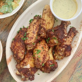 Primal Wings - a plate of chicken wings with a side of salad - Chicken Wings Near Me - Montauk, New York Primal Wings - a plate of chicken wings with a side of salad - Chicken Wings Near Me - Montauk, New York